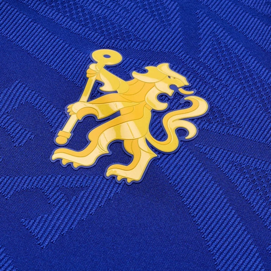 Close up of a heat pressed crest on a player version shirt, smooth and glossy with a raised edge
