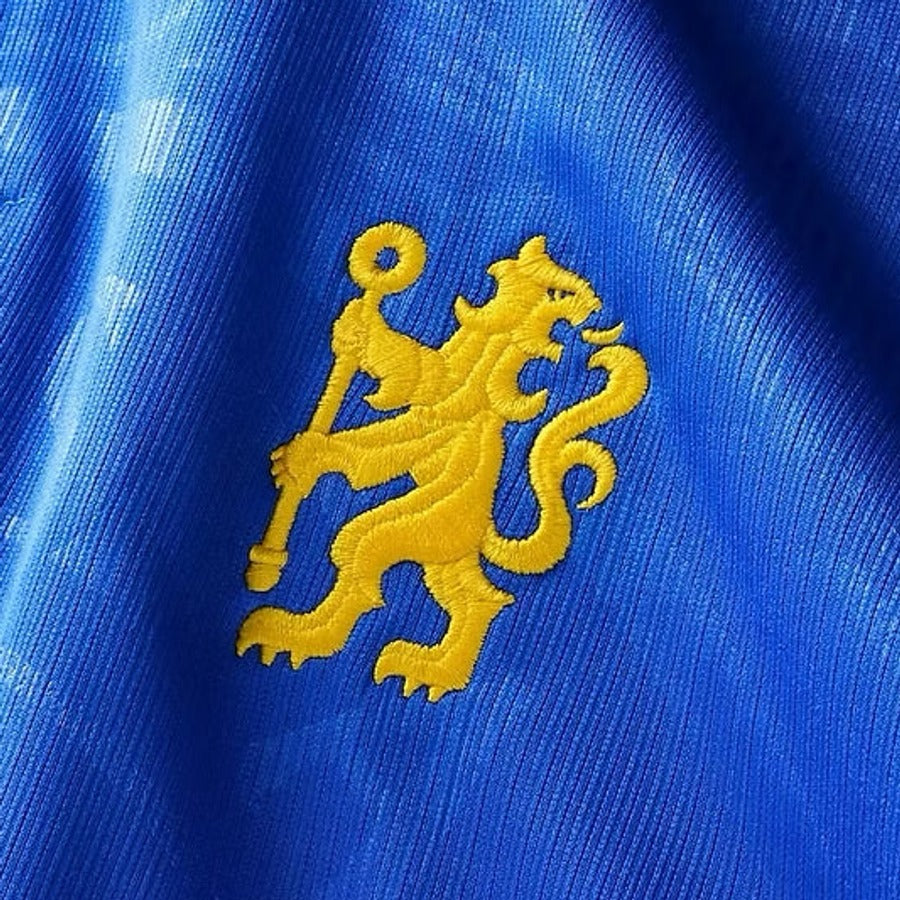 Close up of an embroidered crest on a fan version shirt, stitched in raised satin thread